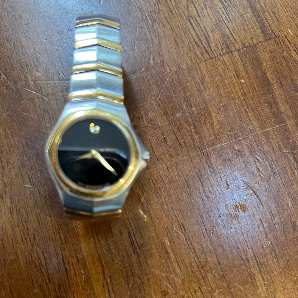 Used Luxury Movado Women’s Gold and Black Watch- has scratches